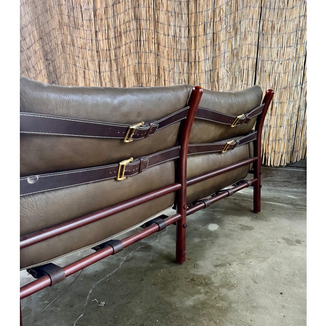 Original Arne Norell Kontiki Sofa. Well-preserved olive leather in great vintage condition with dark brown leather straps...