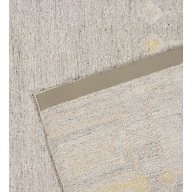 This Kilim is handwoven in India, blending wool and viscose to achieve a unique texture and appearance. Inspired by the...