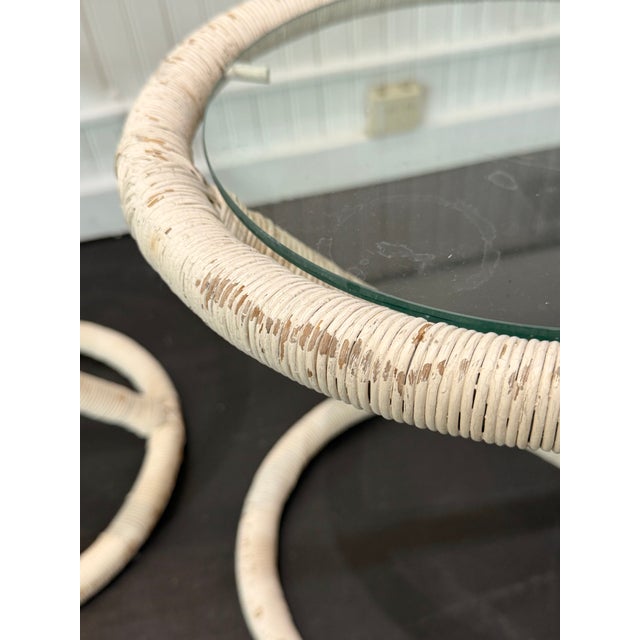 Stylish pair of round vintage side tables with glass tops On Z base , wrapped in white wicker. Distressed finish 14 x 16.5h