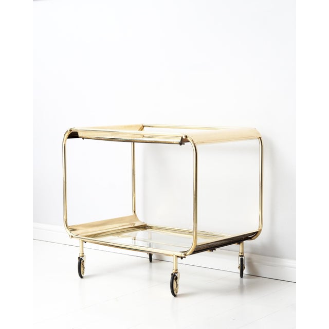 Classic, elegant Art Deco bar cart in brass. France, 1920 - 1930s. Light wear consistent with age and use.
