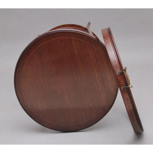 Early 20th Century mahogany three tier tray top occasional table, the inlaid top tier having a removable glass tray, three...