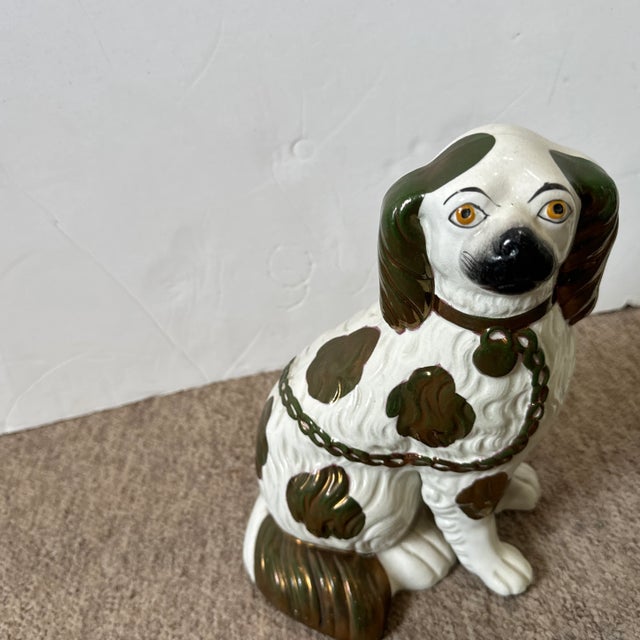 Antique decorative dogs with green glaze and copper luster. Beautiful complement for a mantle or sideboard. Assembled pair.
