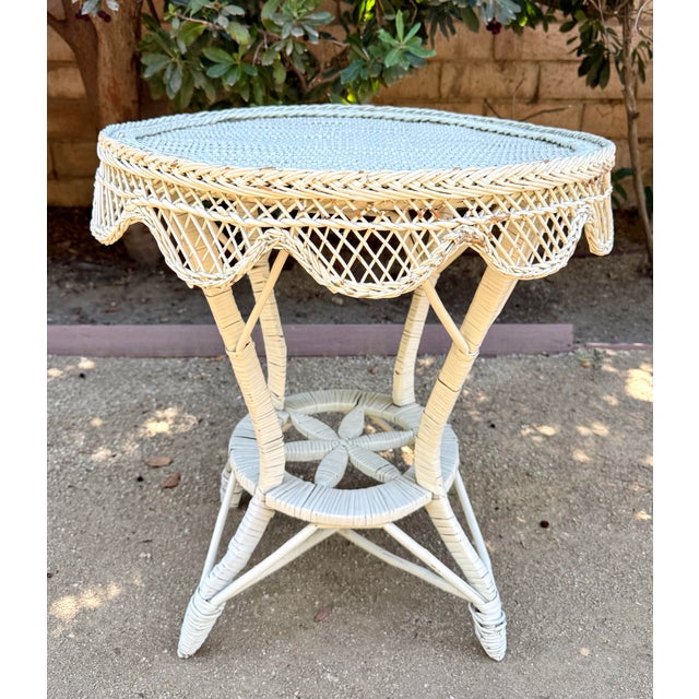 Here is a charming vintage wicker and rattan side table featuring wonderfully detailed woven construction and a softly...