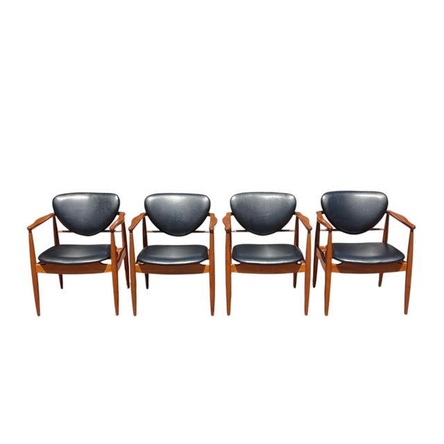 Set of 14 Danish Midcentury Modern Dining Chairs. This set includes 4 armchairs and 10 side chairs. The chairs are...