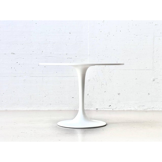 A clean, timeless ikea docksta dining table in white with a distinctive central pedestal. The design incorporates the...