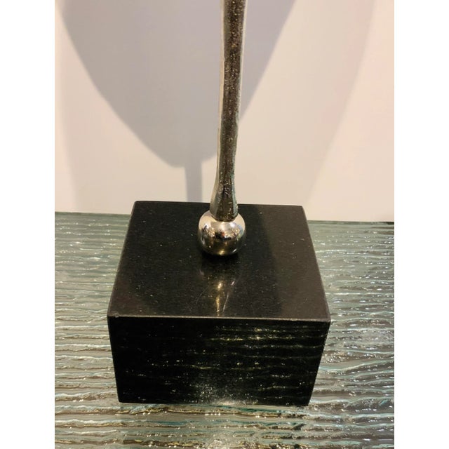 Elegant Polished Nickel Leaf Sculpture, black marble stand, please ignore the reflection in the stand, showroom floor sample