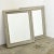 A lovely pair of French 19th century wall mirrors with delicate Neoclassical, scrolled motifs embossed in the recessed...
