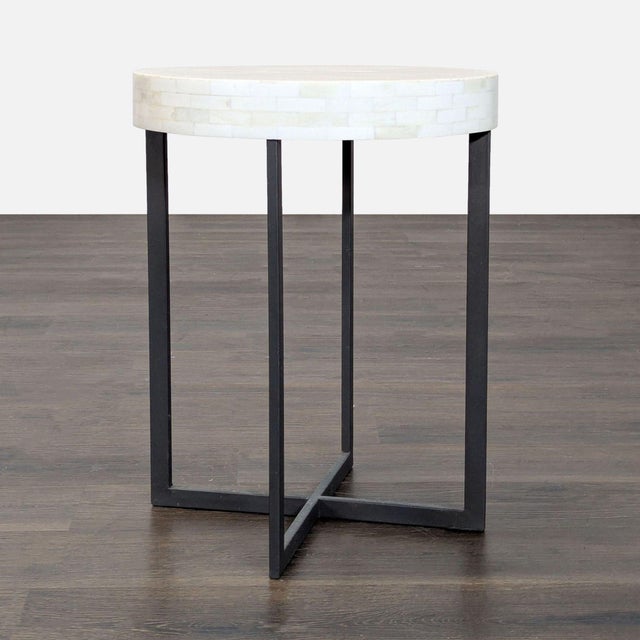 Simple and sculptural, the Bone Side Table is an accent piece that combines an industrial-looking iron crossed base with...