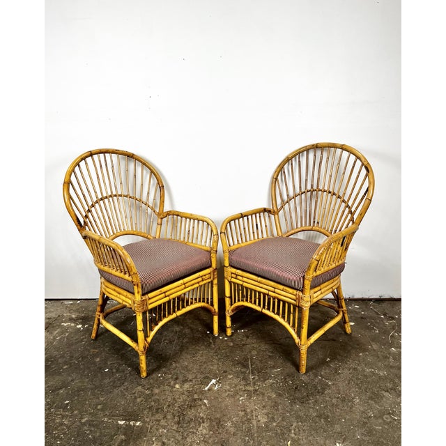 Vintage pair of bamboo/rattan fan back arm chairs. Made in Philippines. Pencil reed backs with triple band trim around...