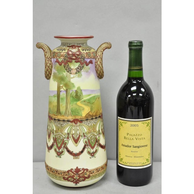 Antique Nippon Hand Painted Porcelain Countryside Moriage Tall Twin Handle Vase. Circa Early 20th Century. Measurements:...