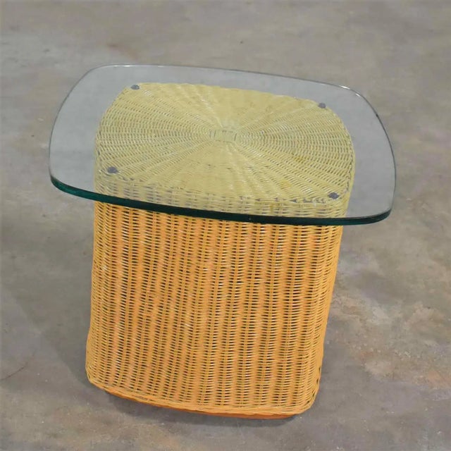 Handsome Coastal, Island, or organic modern rattan wicker side table or end table having a ½ inch thick glass top with an...