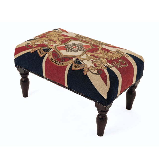 Meticulously handcrafted in the United Kingdom, this upholstered stool boasts classic studding and hand-polished solid...