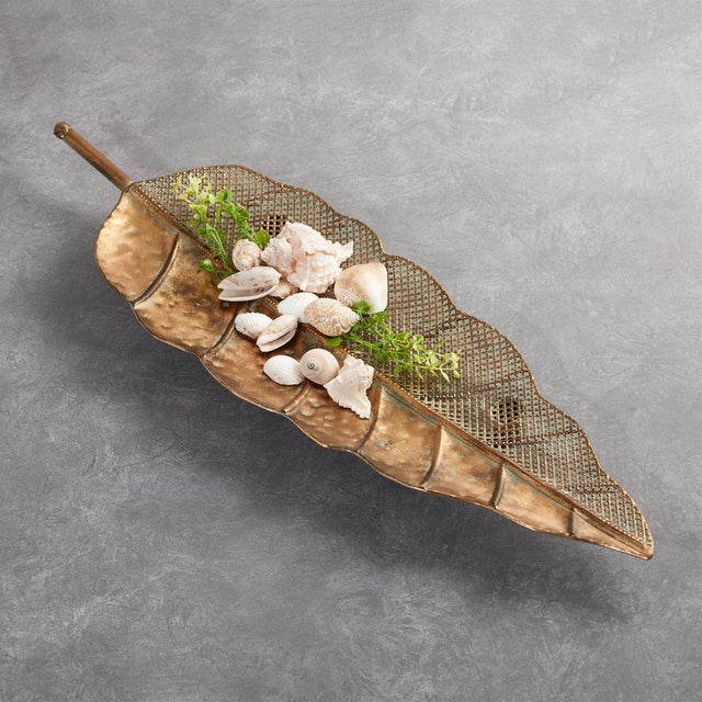 Elevate your decor with the Distressed Metal Leaf Tray Set. Featuring chic gold and patina tones, these trays are crafted...