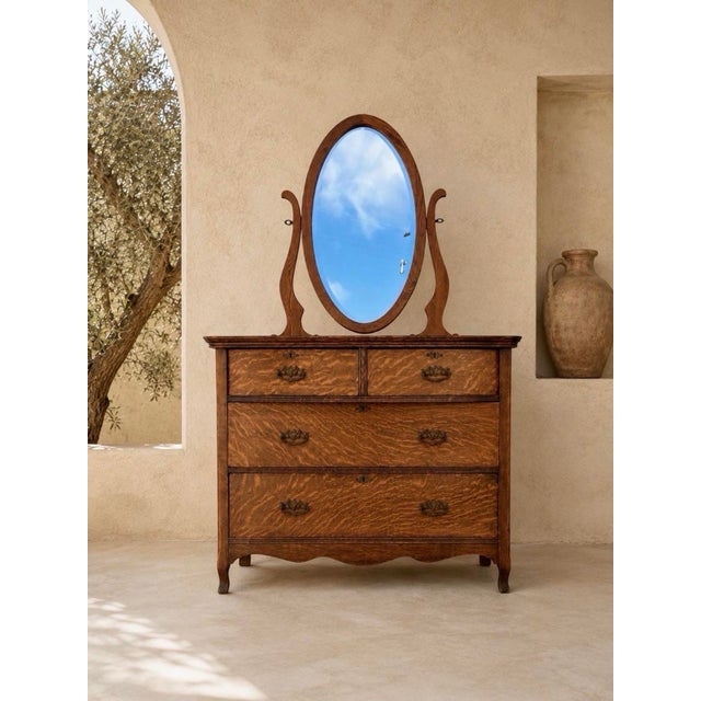 This tiger oak dresser is an antique from the late 19th/ early 20th century. It is known for its distinctive wavy “tiger...