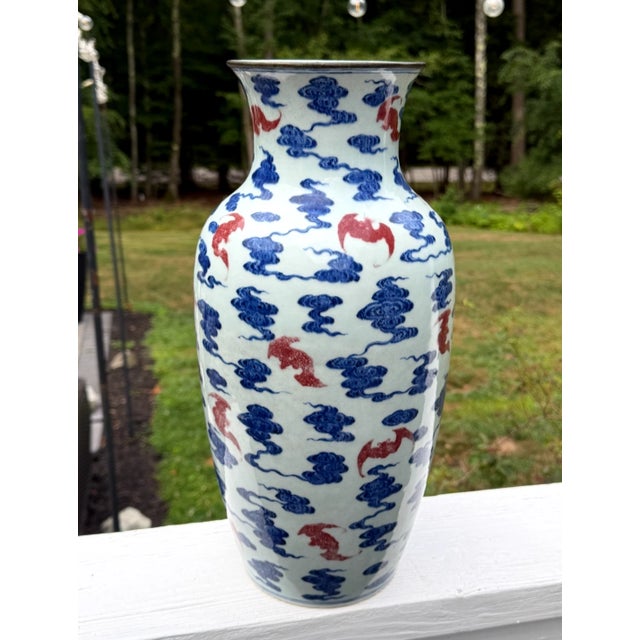 An extraordinary and finely painted antique Chinese porcelain vase decorated in underglaze cobalt blue and copper red....