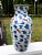An extraordinary and finely painted antique Chinese porcelain vase decorated in underglaze cobalt blue and copper red....
