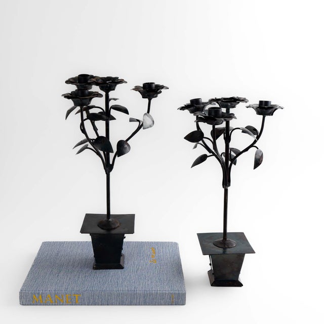 Romantic and sculptural, this pair of vintage iron candleholders features blooming roses and leafy stems, each designed to...