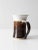 This vintage signed studio pottery pitcher is a beautifully handcrafted ceramic piece featuring a warm brown and white...