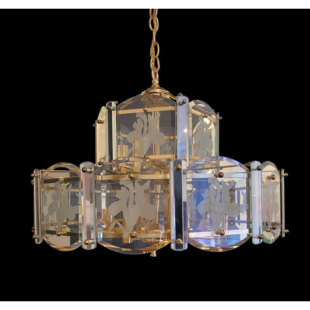 Chandelier measures 23” wide x 18” tall. Chain and brass plate measures 22” in length 13 lights in total Max 40 watts each...