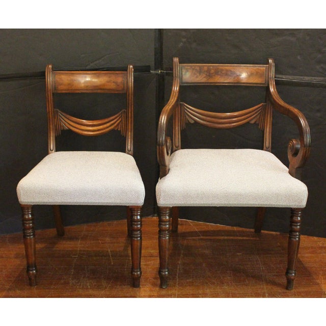 Circa 1830 William IV period set of 8 dining chairs, English. Carved mahogany in Greco-Roman taste. 2 arms & 6 sides. The...