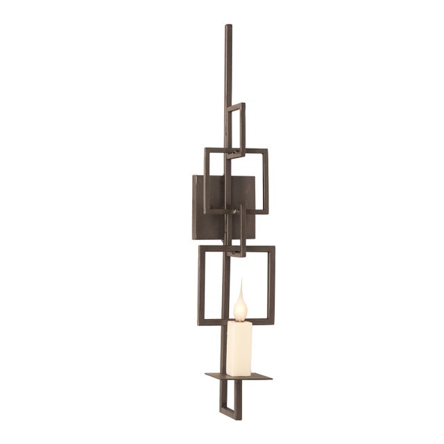 A steel-framed vertical sconce, 30 inches tall and only 6 inches wide, that pulls light downward in a single clean line....
