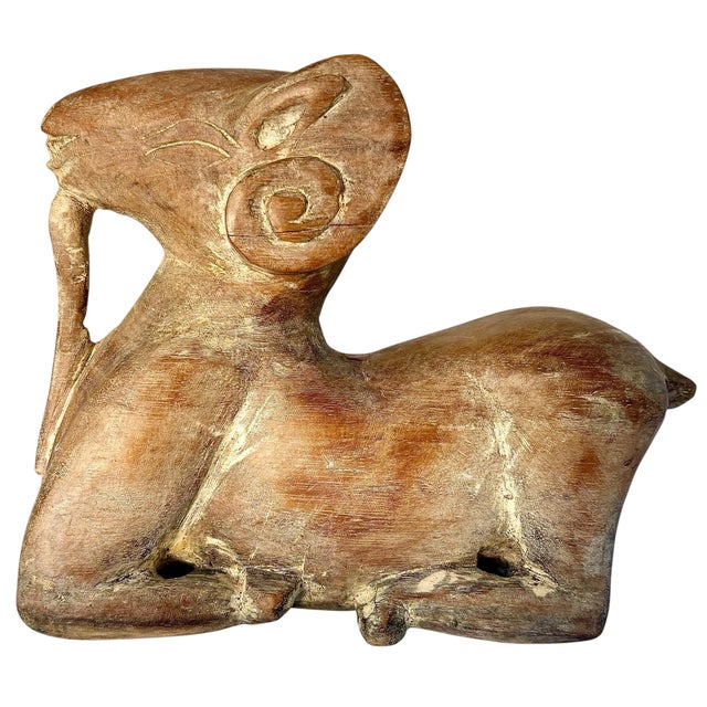 Hand-carved ram sculpture with a bold, sculptural presence and expressive modernist design. This reclining ram is rendered...