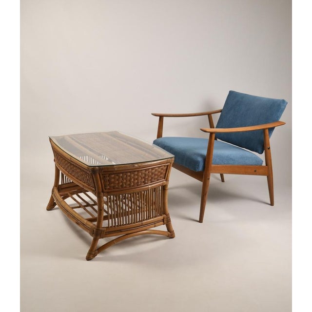 Elegant vintage coffee table crafted from rattan and woven wicker, dating from the 1960s. This piece features a...