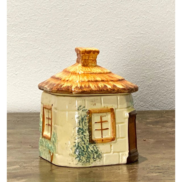 A 20th Century Staffordshire Keel St Potter sugar bowl in the form of a cottage.