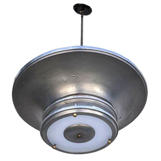 Striking 23" diameter Machine-Age pendant light features a spun aluminum shade with a streamlined saucer with 2 extended...