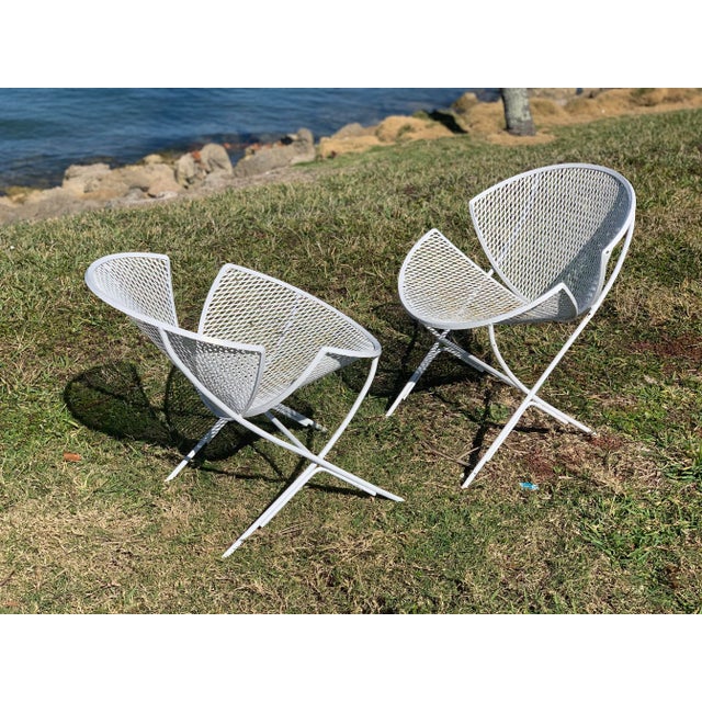 Fabulous pair of vintage 1950s orange slice patio chairs. Made of wrought iron with original white paint, these chairs are...
