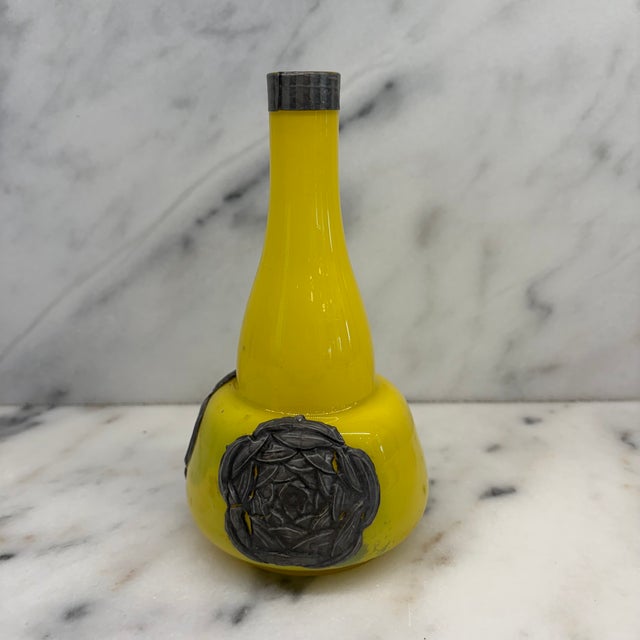Striking French yellow Art Nouveau glass vase featuring a sculptural long-necked form accented with dark pressed silver...