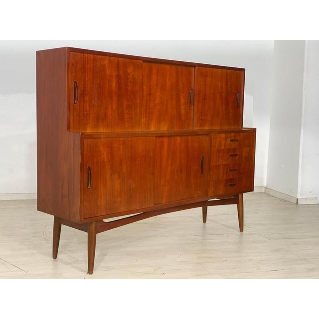A very nice vintage teak highboard. • Danish Design • 60s • Sliding doors • 4 drawers • good condition Dimensions: Height:...