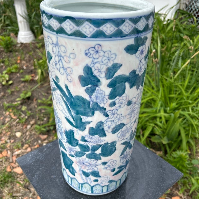 This Vintage Blue and White Chinoiserie Porcelain Hand-Painted Floral Umbrella Stand showcasing intricate Chinese culture...