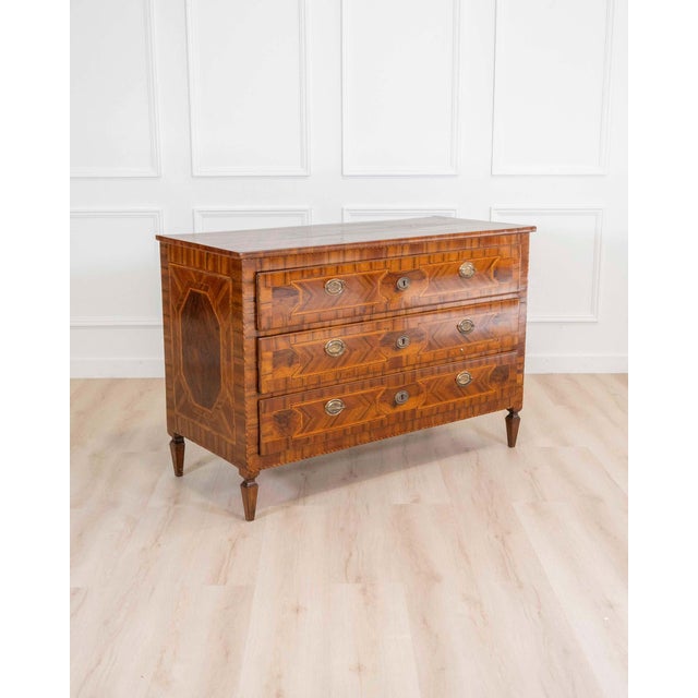 An exceptional 18th century Modenese Louis XVI chest of drawers, masterfully crafted in walnut and richly inlaid with...