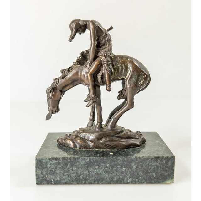 We are selling this small miniature bronze of End of the Trail after James Fraser mounted on a green marble base....