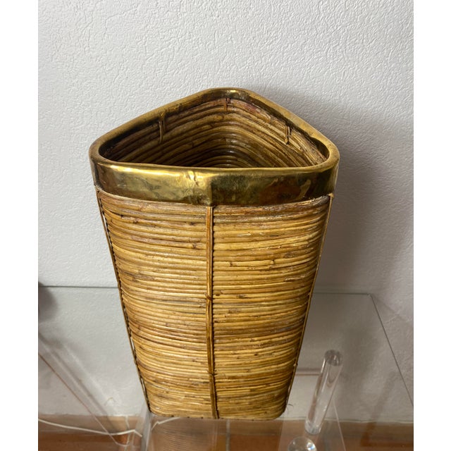 Brass-rimmed rattan umbrella stand. Unusual triangular shape. Italy, 1970s. In used condition, wood missing from the lower...