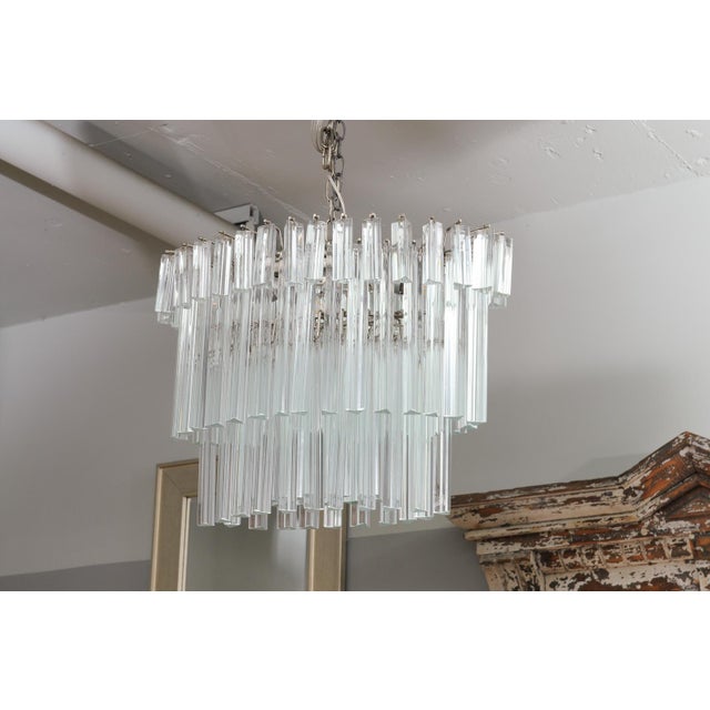 This beautiful Venini style chandelier is draped with three different sizes of heavy trihedral glass prisms. The differing...
