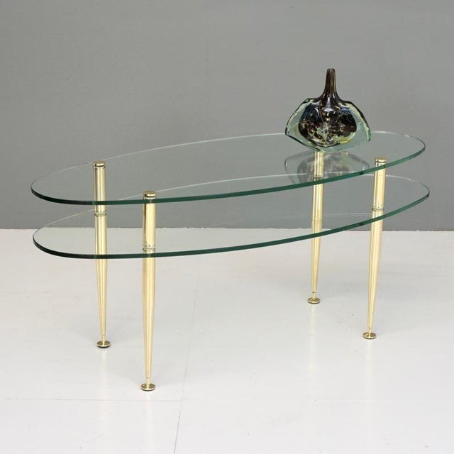 Stylish French double tiered coffee table on brass supports. France Circa 1950 H 46.5cm x W 104cm x D 44.5cm (Lower Tier...
