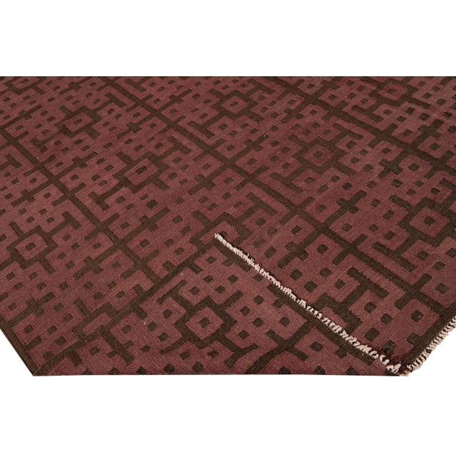 Beautiful modern Kilim flat-weave wool rug with a marron field. This piece of art has brown accents in a gorgeous...