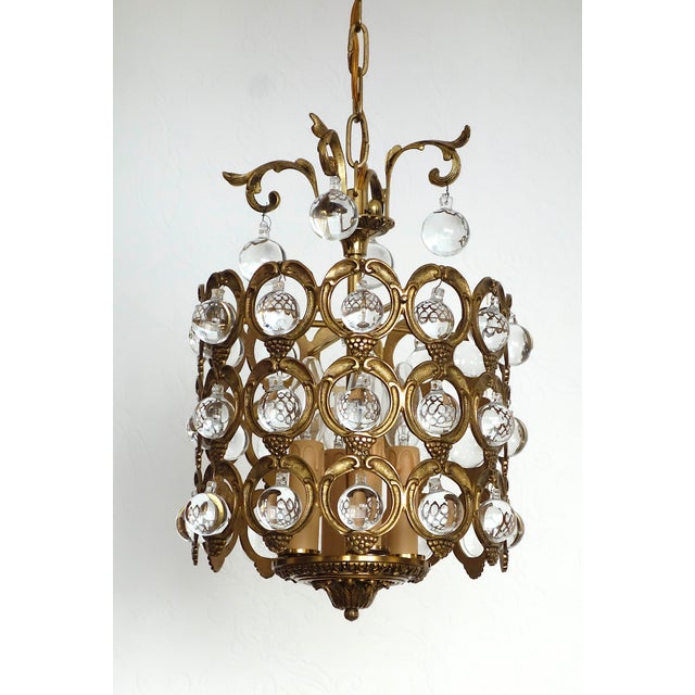 Antique French Brass and Crystal Ball 4-Light Chandelier, 1930s, in Very Good conditions. Designed 1920 to 1949 I have...