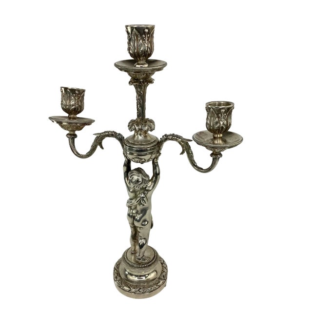 Pair of 19th C French Silvered Bronze Putti Candelabra. Features a Bronze draped putti holding up a three branch...