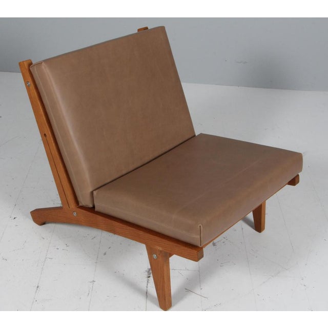 Hans j. Wegner lounge chair with loose cushions new upholstered with full grain aniline leather from sørensen. Frame of...