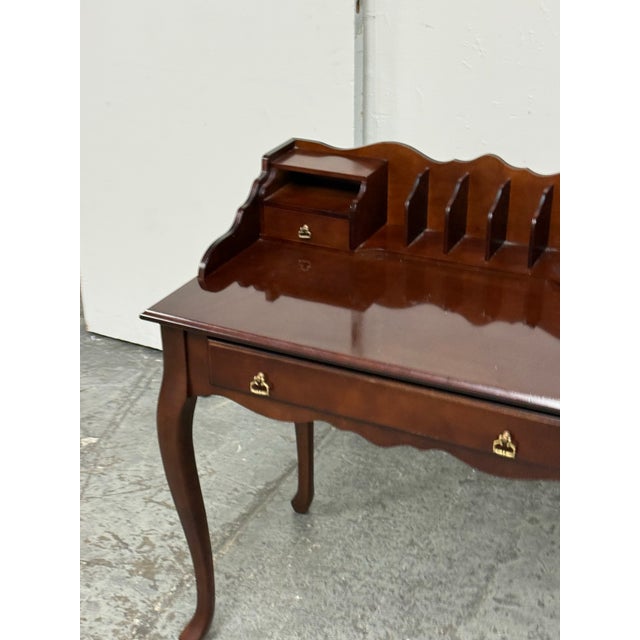 Design Plus Gallery presents a Secretary Writing Desk from Bombay Company. The traditional wood desk has a shaped...