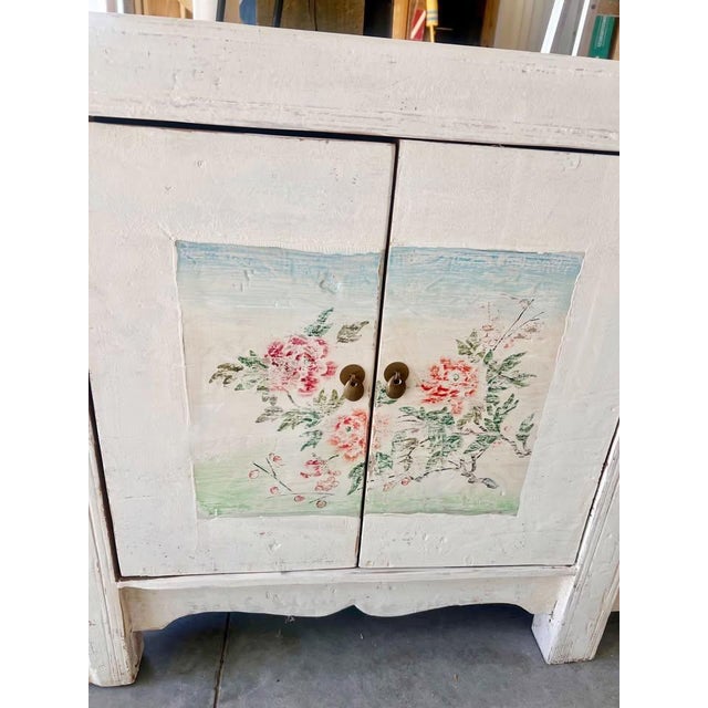 One-of-a-kind antique vintage 1900's handmade carved Asian sideboard cabinet with original hand-painted florals. The...