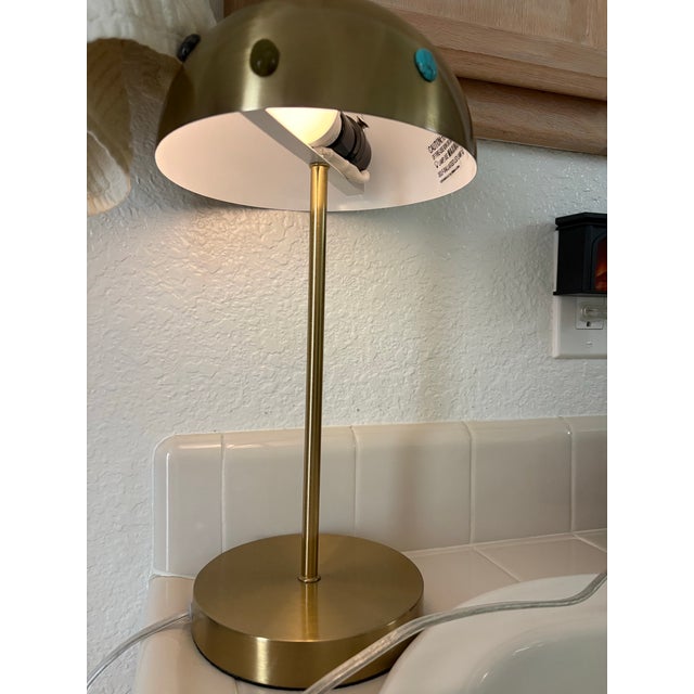 Upcycled gold toned metal desk lamp adorned with an assortment of colorful semiprecious stone agate accents on the shade....