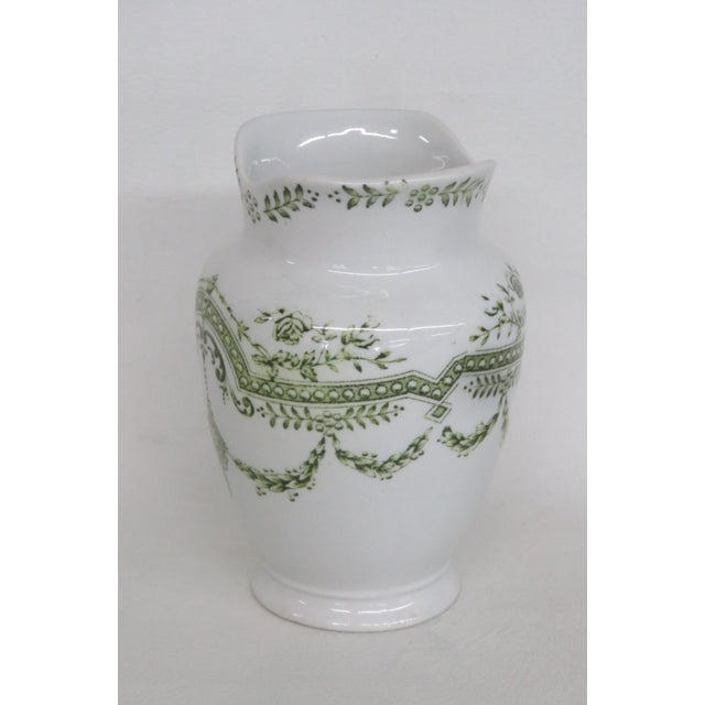 This charming Small Vase is made out of Earthenware pottery. This compact decorative vessel is marked on the bottom as...