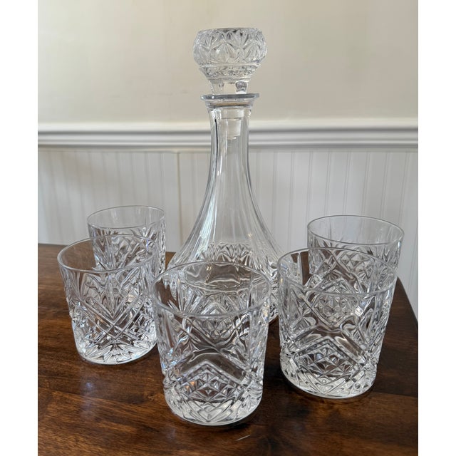 This set includes a “Fascination” Cristal de’ Flandre France Decanter and five Cristal D’ Arques “Masquerade” tumblers...