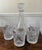This set includes a “Fascination” Cristal de’ Flandre France Decanter and five Cristal D’ Arques “Masquerade” tumblers...