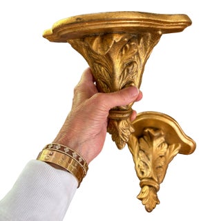 A Pair of Gold Gilded Wall Mounted Shelves For Sale