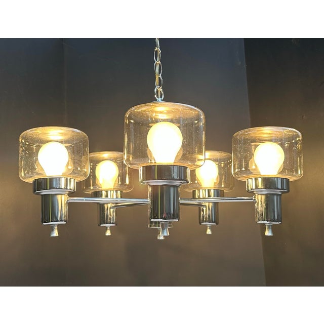 Very handsome 1970s chrome and clear glass 5-light chandelier. Unmarked but likely by Gaetano Sciolari for Lightolier....